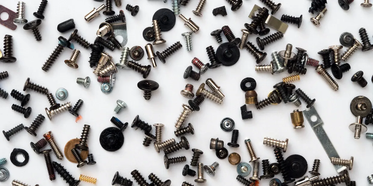 A multi-bit ratcheting screwdriver with bits laid out on a workbench
